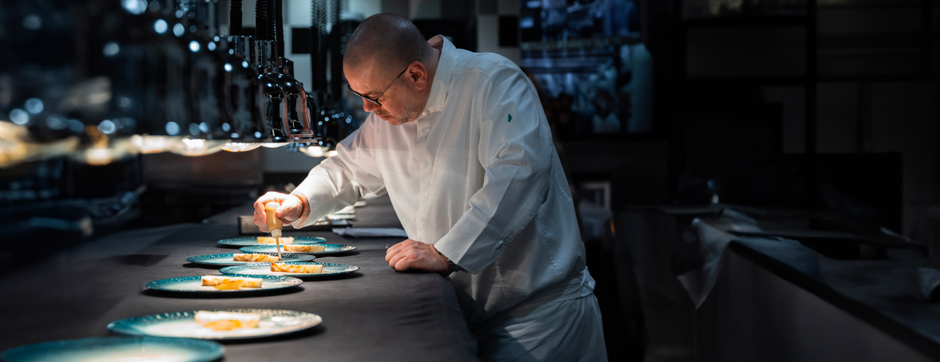 Chef meticulously plating a course